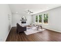 Inviting living room with hardwood floors, modern fireplace, and an abundance of natural light at 244 Potomac River St, Garner, NC 27529
