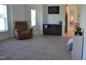 Spacious living room features plush carpet, a cozy recliner, and built-in cabinets at 2912 Epps Clark Rd, Siler City, NC 27344