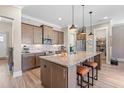 Modern kitchen with granite countertops, stainless steel appliances, and an oversized island at 345 Warm Wind Dr, Clayton, NC 27527