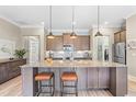 Open kitchen with granite countertops, stainless steel appliances, and a breakfast bar with seating at 345 Warm Wind Dr, Clayton, NC 27527