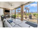 Relaxing screened porch with a stone fireplace, comfortable seating, and beautiful backyard views at 345 Warm Wind Dr, Clayton, NC 27527