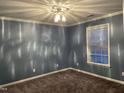 Cozy bedroom with plush carpeting, soft lighting, and a window providing natural light at 3489 Forestdale Dr # 2D, Burlington, NC 27215