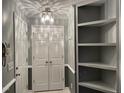 Hallway with built-in shelving, closet, and attractive overhead lighting fixture at 3489 Forestdale Dr # 2D, Burlington, NC 27215