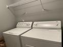 Functional laundry room with washer, dryer, and convenient overhead shelving at 3489 Forestdale Dr # 2D, Burlington, NC 27215