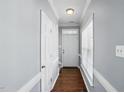 Inviting hallway with hardwood floors leading to a white front door and window at 368 Bayleigh Ct, Garner, NC 27529
