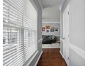 Bright hallway with hardwood floors leading to a cozy living room, bathed in natural light at 368 Bayleigh Ct, Garner, NC 27529
