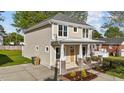 Inviting two-story home showcases a classic design with a cozy porch, manicured lawn, and a driveway at 408 W Stallings St, Clayton, NC 27520