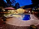 Inviting backyard oasis with a sparkling in-ground pool, lounge chairs, and an umbrella for relaxation at 4405 Brighton Ridge Dr, Apex, NC 27539