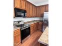 Kitchen with stainless steel oven and refrigerator with wood cabinets and countertops at 4509 Joe Cotton Dr, Knightdale, NC 27545