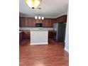 Open kitchen featuring wood cabinets, stainless steel appliances and central island at 4509 Joe Cotton Dr, Knightdale, NC 27545