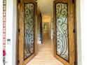 View of open double doors leading into a foyer with hardwood floors and a staircase to the second floor at 5025 Martin Farm Rd, Raleigh, NC 27613