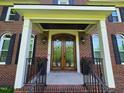 Elegant brick home featuring a beautiful, decorative glass double-door entrance with charming curb appeal at 5025 Martin Farm Rd, Raleigh, NC 27613