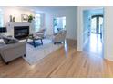 Bright living room features a fireplace, hardwood floors and neutral color palette at 5025 Martin Farm Rd, Raleigh, NC 27613