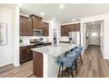 Modern kitchen features a large island with seating and stainless steel appliances at 648 White Birch Ln, Angier, NC 27501