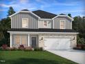 Charming home with a brick and gray facade, complemented by a lush lawn and colorful landscaping for curb appeal at 658 White Birch Ln, Angier, NC 27501