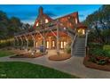 Stunning log home with an expansive stone patio, outdoor grill, and inviting backyard space at 6707 Frieden Church Rd, Gibsonville, NC 27249