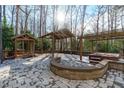 Beautiful outdoor space features a stone patio with gazebo and hot tub, perfect for entertaining at 7116 Asheway Dr, Holly Springs, NC 27540