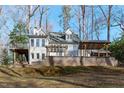 View of the rear of the home, showcasing the spacious patio and upper level deck at 7116 Asheway Dr, Holly Springs, NC 27540
