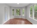 Cozy bonus room with wood floors, a large bay window, and neutral walls at 7116 Asheway Dr, Holly Springs, NC 27540