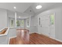 Bright entryway featuring wood floors, neutral paint, and lots of windows and natural light at 7116 Asheway Dr, Holly Springs, NC 27540