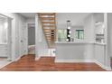 Modern staircase with wood treads and dark floors, bright with lots of light at 7116 Asheway Dr, Holly Springs, NC 27540