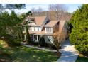 Aerial view of a stately home with a large lot, mature trees, and a well-maintained lawn at 7516 Orchard Crest Ct, Apex, NC 27539