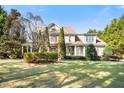 Stately two-story home with a well-manicured lawn and mature trees in a desirable neighborhood at 7516 Orchard Crest Ct, Apex, NC 27539