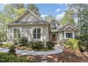 Charming home featuring light gray siding, a dark roof, and a beautiful arched window over the front door at 81008 Alexander, Chapel Hill, NC 27517