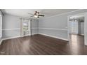 Bright living room featuring laminate flooring, neutral walls, and a ceiling fan at 8163 Julian Rd, Dunn, NC 28334