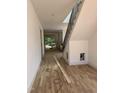 Bright foyer with beautiful hardwood flooring and a staircase with black metal railings at 1002 Canterbury Rd, Raleigh, NC 27607