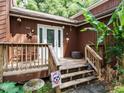 A covered porch featuring a wooden deck with steps up to the front door at 112 Cameron Ct, Cary, NC 27511