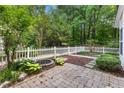 Secluded backyard featuring a patio, a built-in fire pit, and a lovely garden area with lush greenery at 11710 Mezzanine Dr # 101, Raleigh, NC 27614