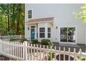 Charming home featuring a blue front door, bay window, and white picket fence at 11710 Mezzanine Dr # 101, Raleigh, NC 27614