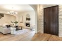 Cozy living room with fireplace, stone accents, wood flooring, and modern decor at 1222 Duplin Rd, Raleigh, NC 27607