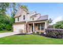 Charming two-story home features a two-car garage and manicured front lawn at 124 Owensboro Ct, Raleigh, NC 27603