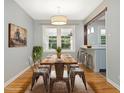 Charming dining room featuring a wooden table, modern lighting, and adjacent breakfast bar at 1521 N Duke St, Durham, NC 27701