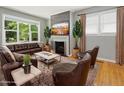 Comfortable living room with fireplace, stylish furniture, and large windows for natural light at 1521 N Duke St, Durham, NC 27701