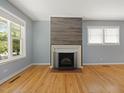 Bright living room with hardwood floors, fireplace, and large windows at 1521 N Duke St, Durham, NC 27701
