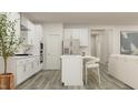 Well-lit modern kitchen features an island with counter seating and stainless appliances at 1581 Goldfinch Perch Ln, Knightdale, NC 27545