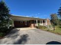 Charming brick house with a covered carport and a driveway leading to the entrance at 167 Chic Ennis Rd, Coats, NC 27521