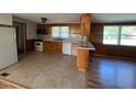 Kitchen and dining area features wooden cabinets, tiled flooring, and wood paneling at 167 Chic Ennis Rd, Coats, NC 27521