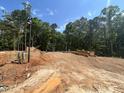 New home construction featuring the completed foundation surrounded by lush trees at 188 Landon Ridge, Sanford, NC 27330