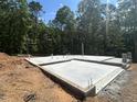 Image of newly poured foundation ready for framing, surrounded by lush trees at 188 Landon Ridge, Sanford, NC 27330