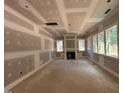 Spacious living room with a fireplace, large windows, and recessed lighting at 188 Landon Ridge, Sanford, NC 27330