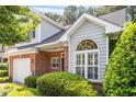 Charming brick home with a well-manicured lawn, attached garage, and beautiful window at 2089 White Pond Ct, Apex, NC 27523