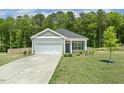Inviting one-story home boasts a well-kept lawn and a convenient two-car garage for easy parking at 230 Forest Meadow Ln, Franklinton, NC 27525