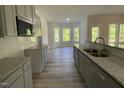 Well-lit kitchen featuring stainless appliances and an eat-in area at 253 Busterfield Ct, Benson, NC 27504