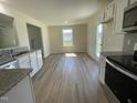 Bright kitchen with granite countertops, stainless appliances, and an eat-in area at 253 Lotus Ave, Smithfield, NC 27577