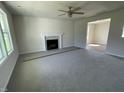 Spacious living room featuring a fireplace, plush carpeting and a bright, sunlit window at 253 Lotus Ave, Smithfield, NC 27577