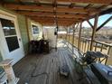 Outdoor deck area showcasing wood flooring, overhead lighting, and backyard scenery at 302 N 12Th St, Erwin, NC 28339